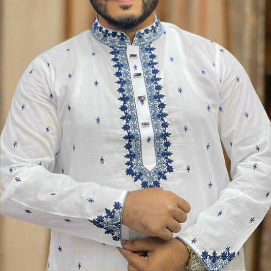 White embroidered panjabi with blue patterns worn by a person in a store setting
