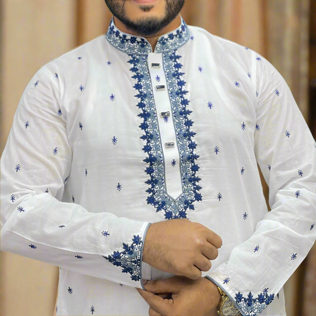 White embroidered panjabi with blue patterns worn by a person in a store setting